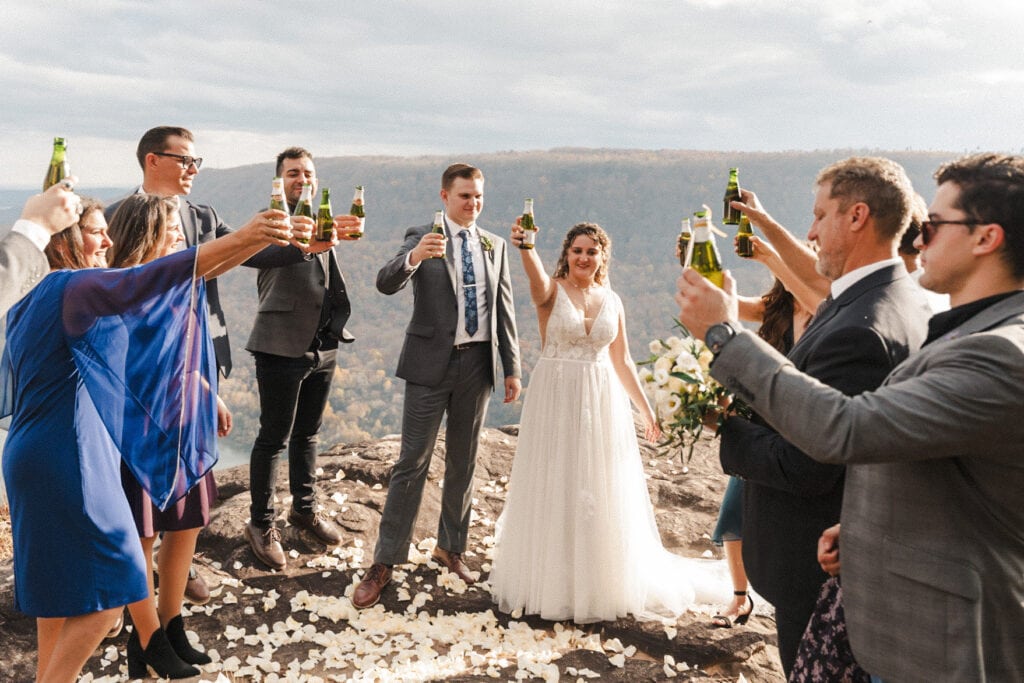 couple eloping on an overlook with their close family