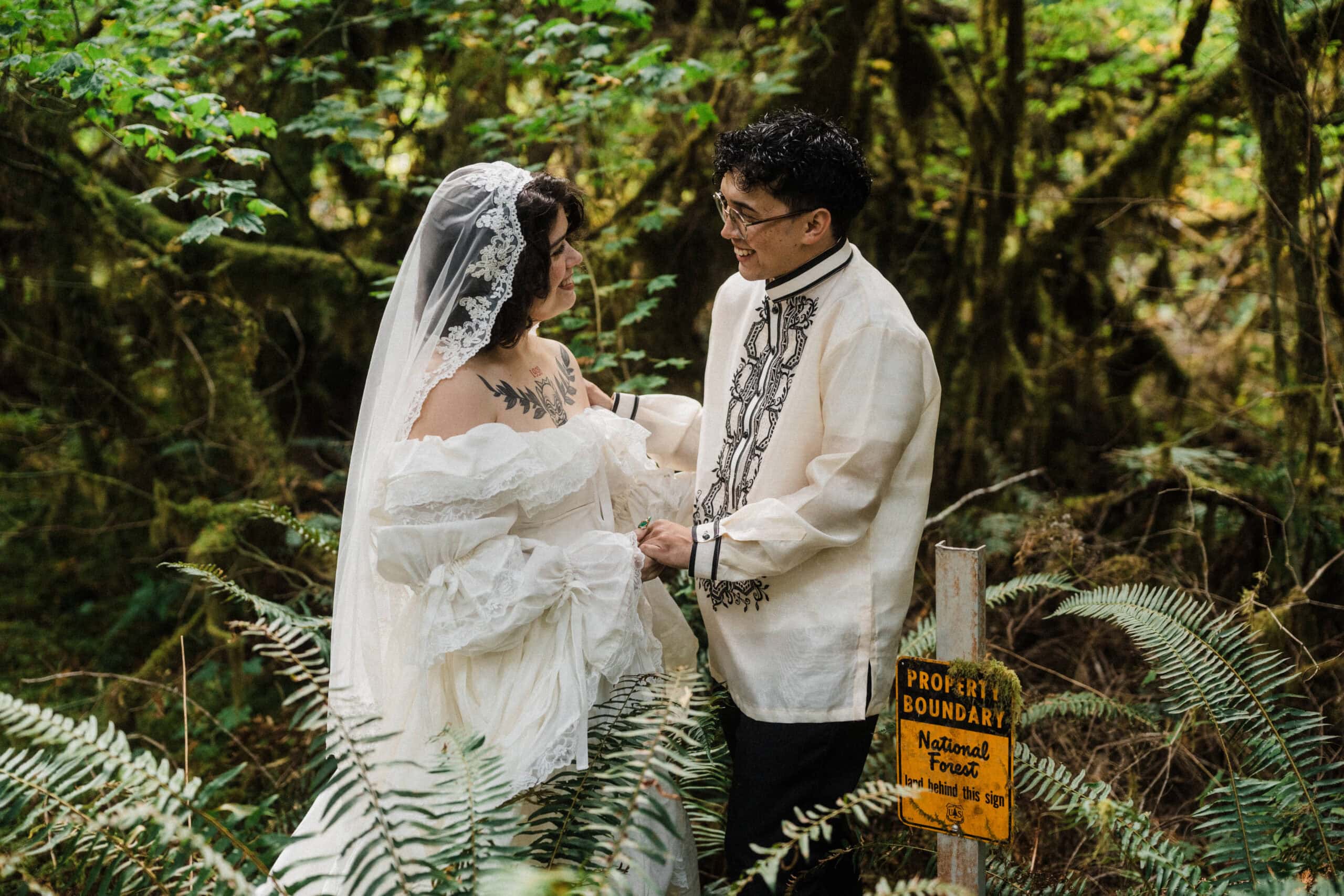 elopement couple surrounded by lush green ferns during their north cascades elopement