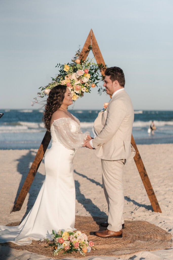 St. augustine elopement photographer takes photo of couple on the beach exchanging wedding vows