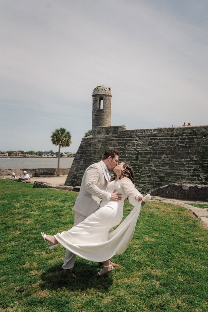 St. Augustine elopement photographer takes photos of couple in front of Castillo de San Marco.