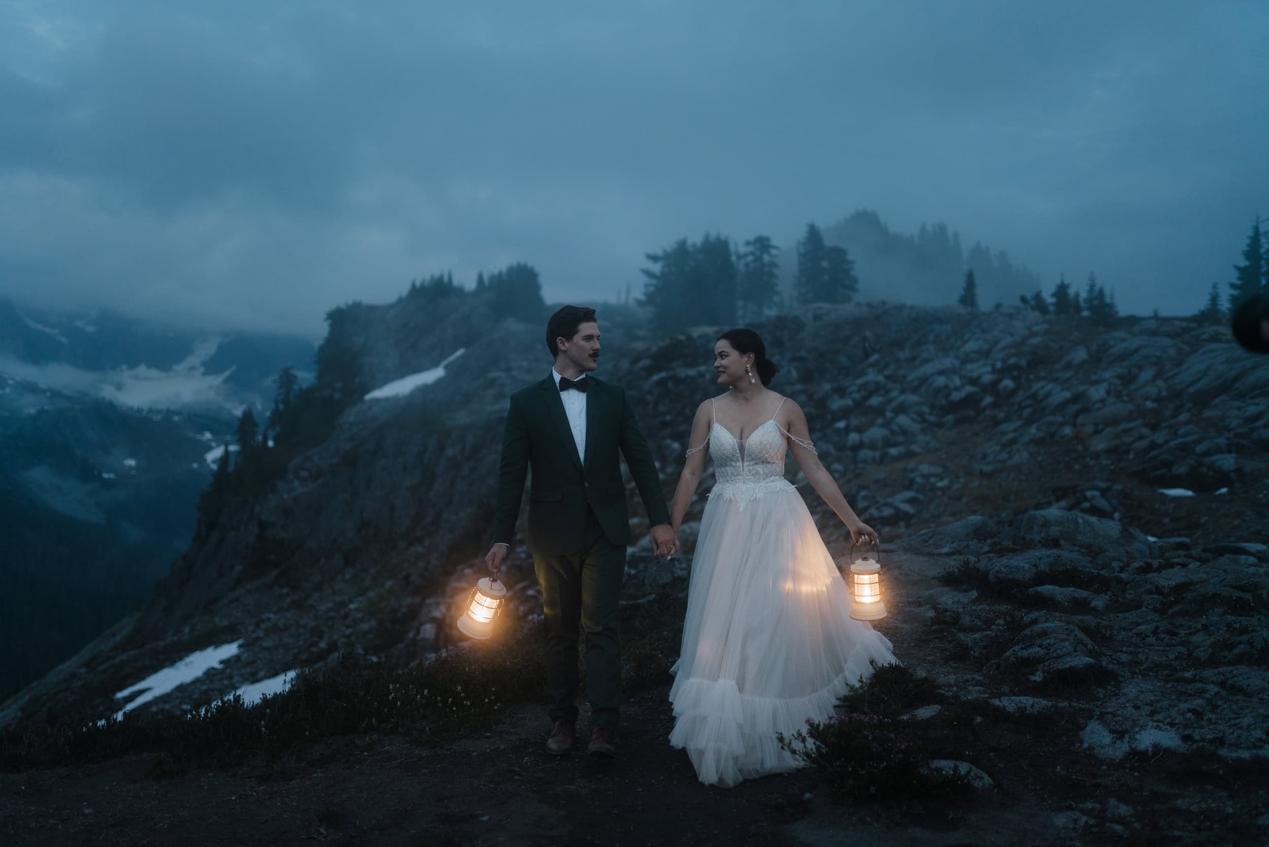 bride and groom walk with mountains in the background after their Artist Point, Washington elopement