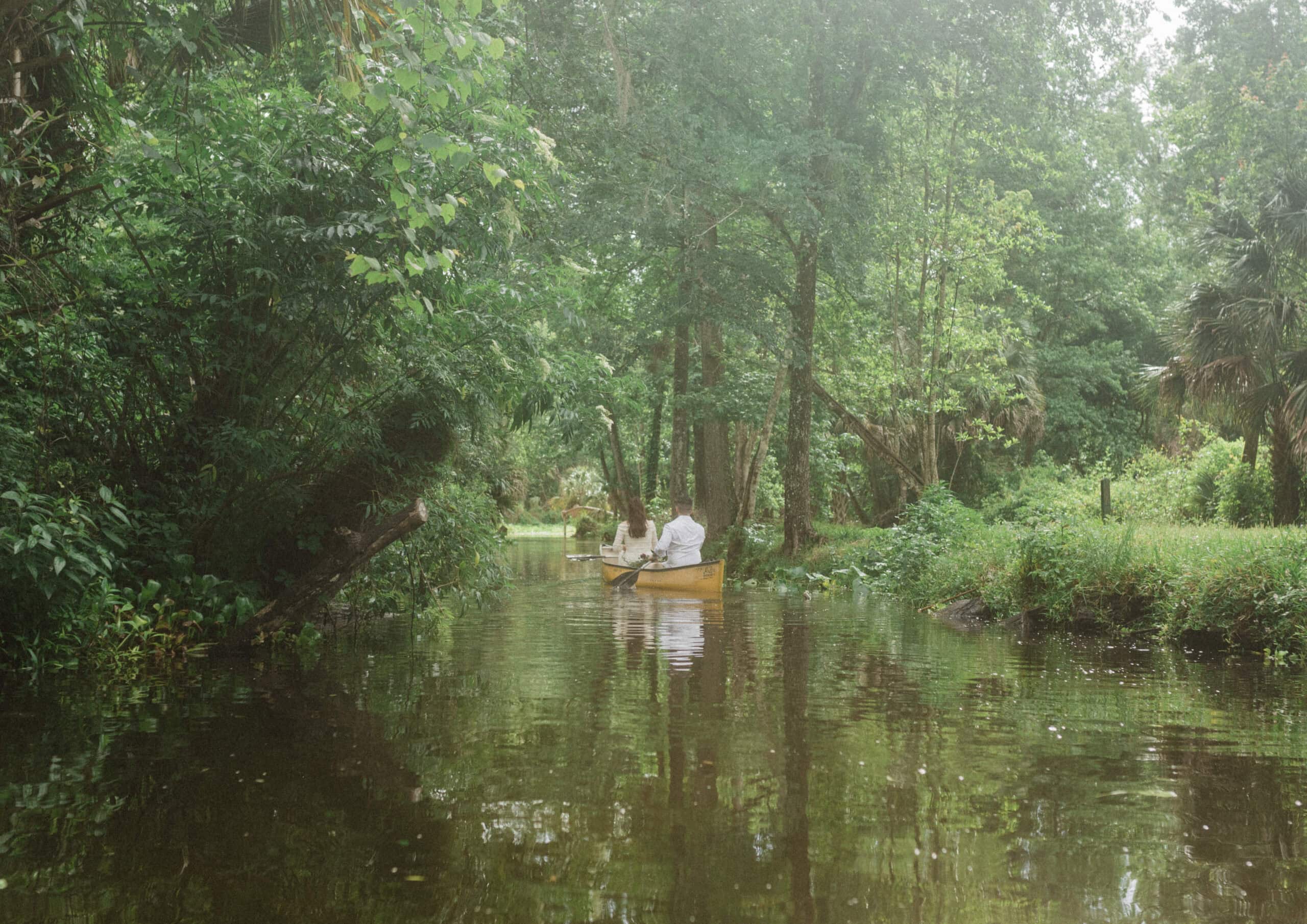 elopement couple sailing together in a kayak during their Florida springs elopement