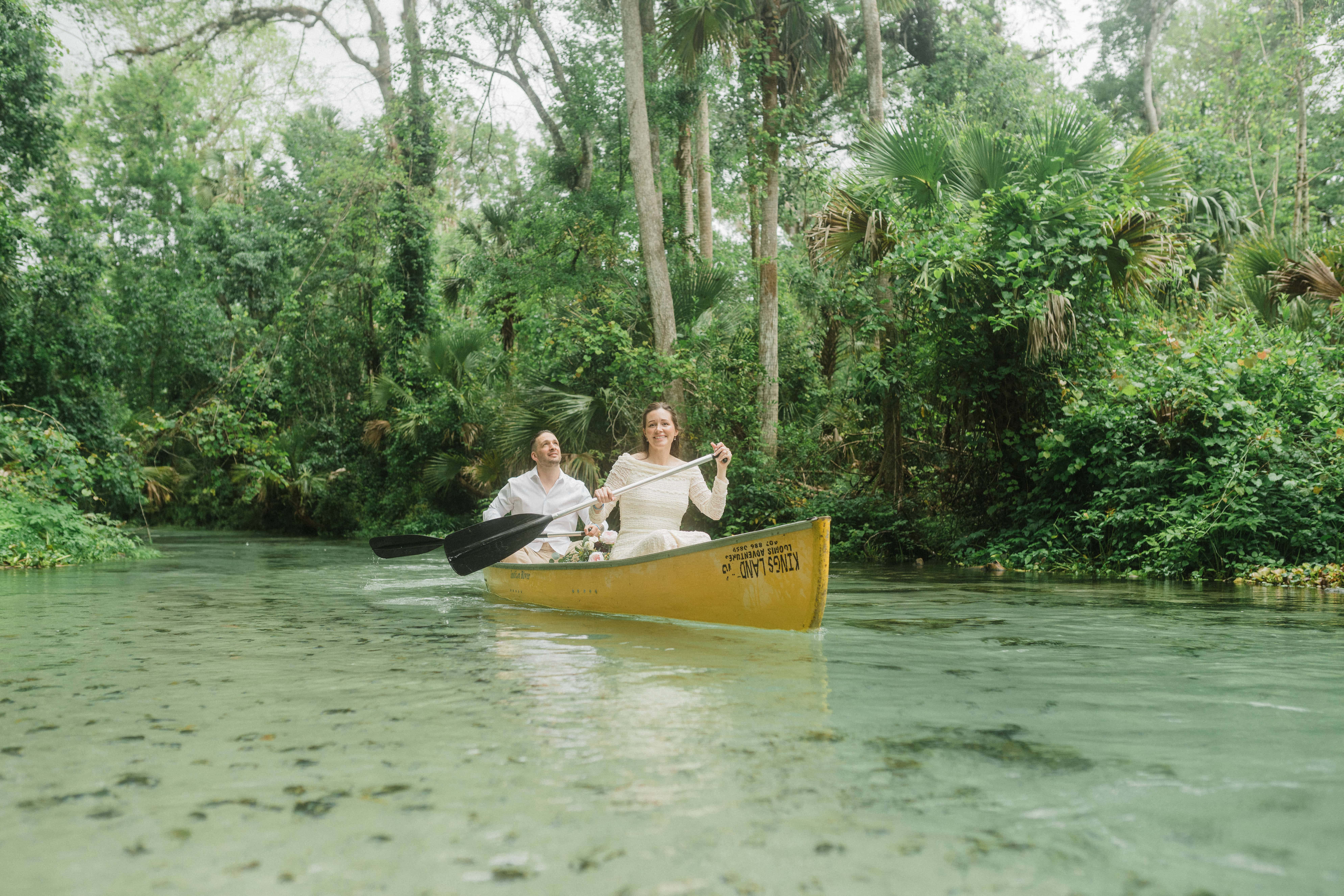 elopement couple sailing together in a kayak during their Florida springs elopement