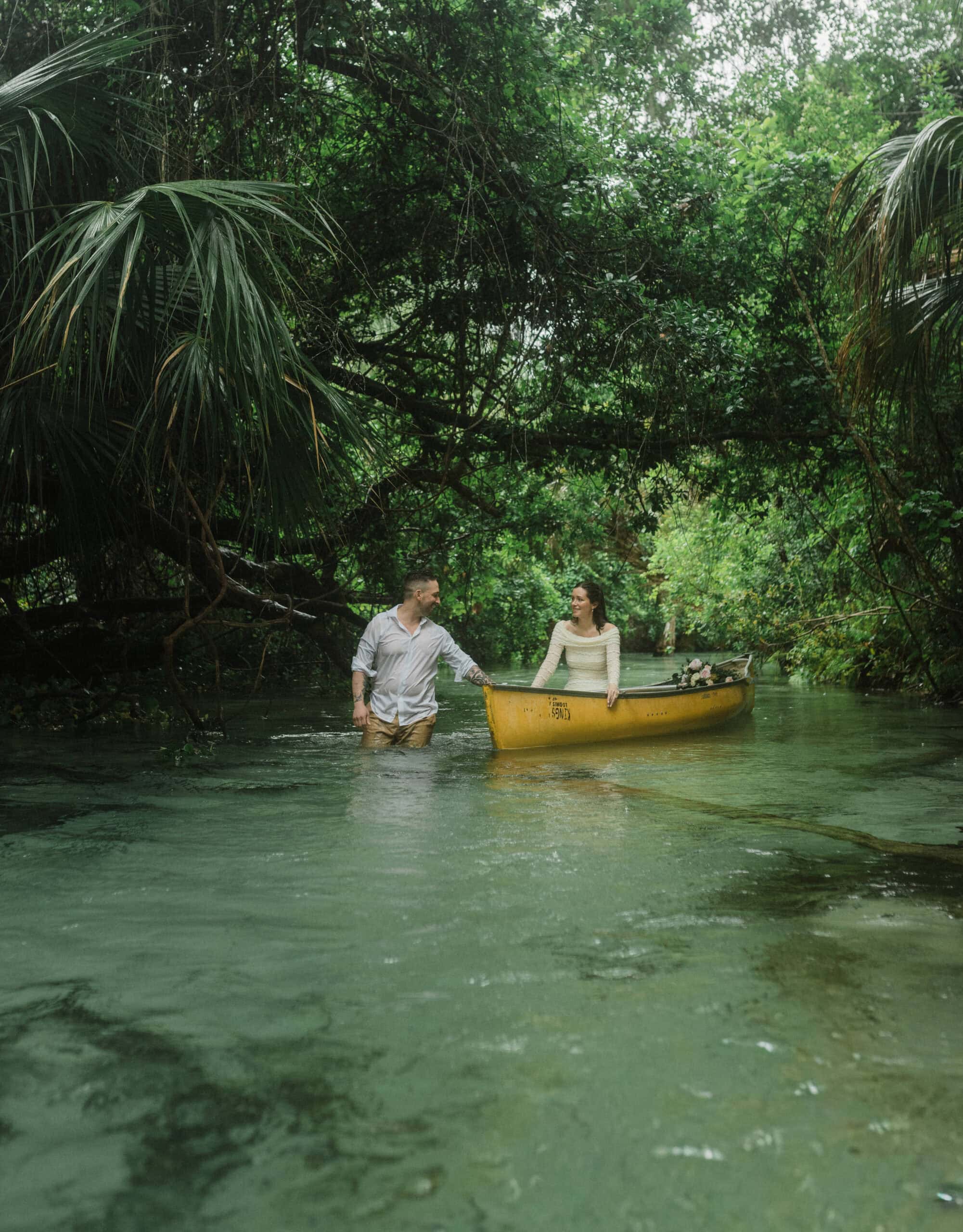 elopement couple kayaking in one of the springs during Florida Springs elopement