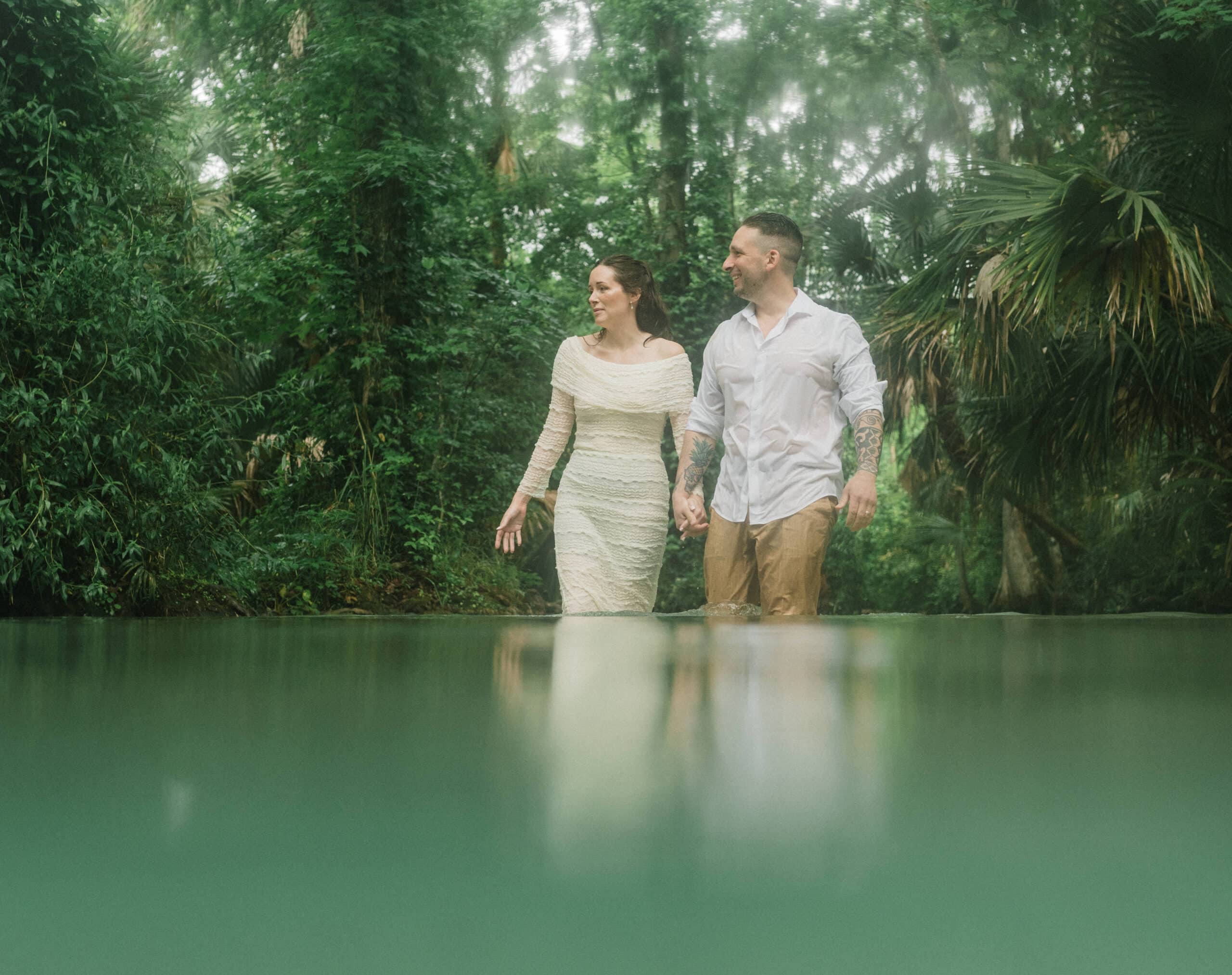 elopement couple standing in water during their Florida Springs Elopement at Kelly Park
