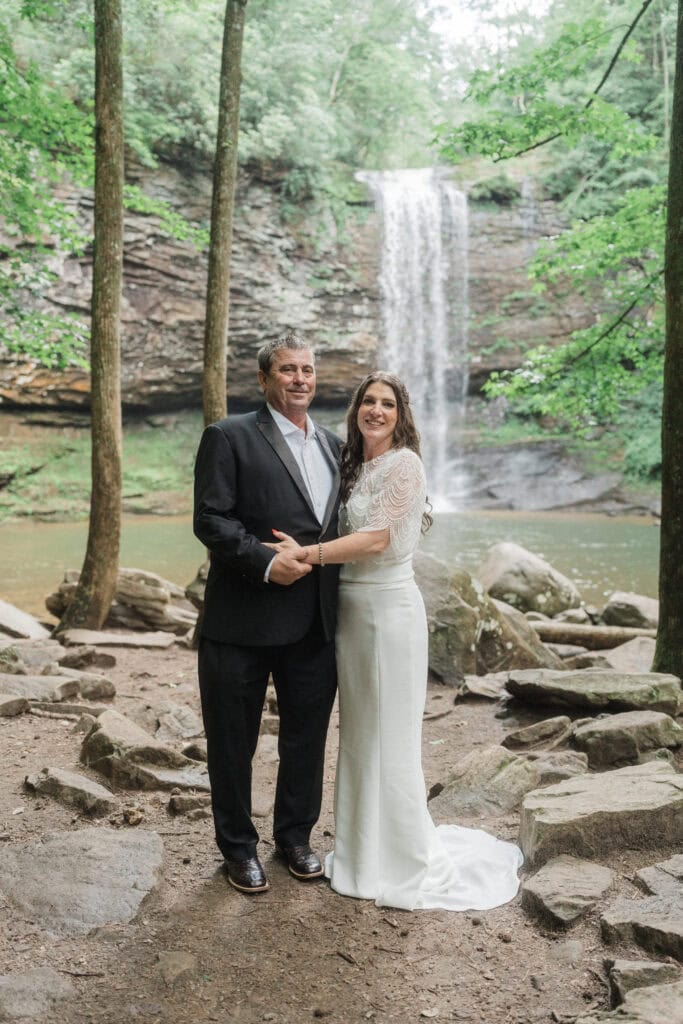 elopement couple standing at a waterfall during a cloudland canyon elopement