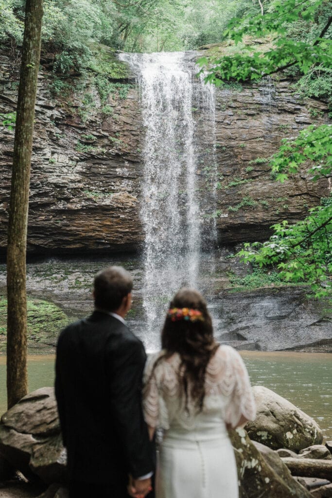elopement couple standing at a waterfall during a cloudland canyon elopement