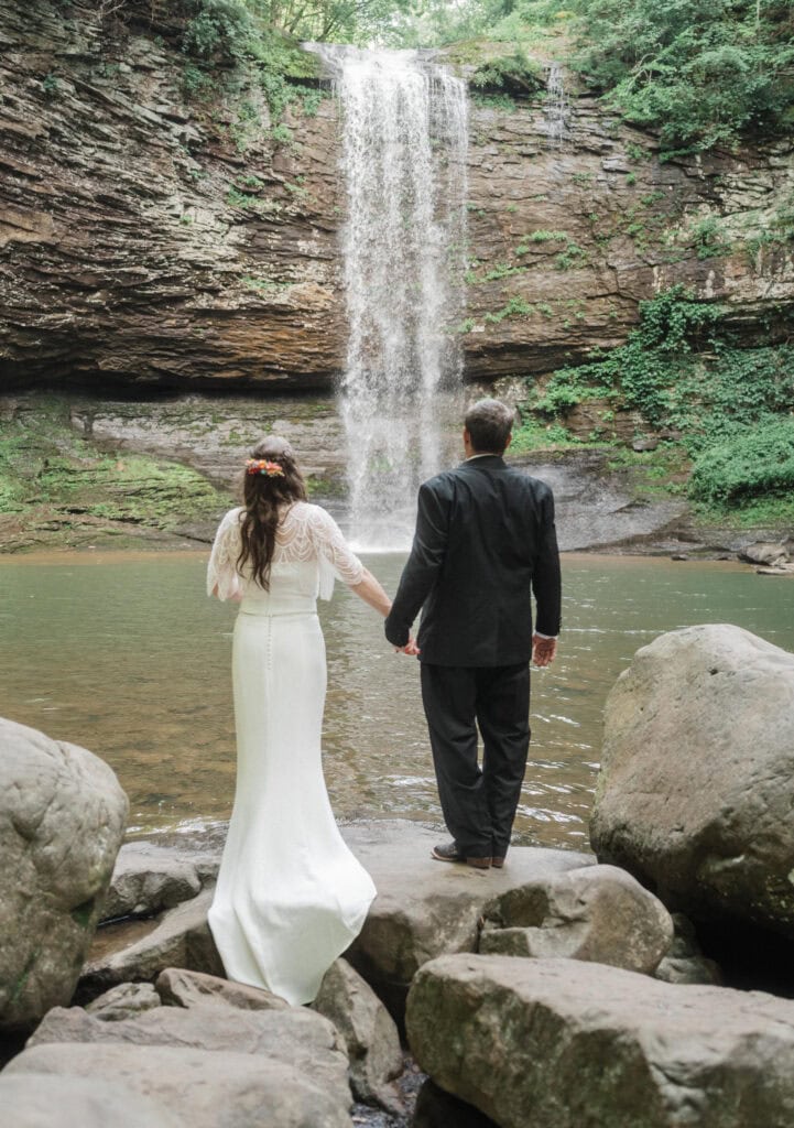 elopement couple standing at a waterfall during a cloudland canyon elopement