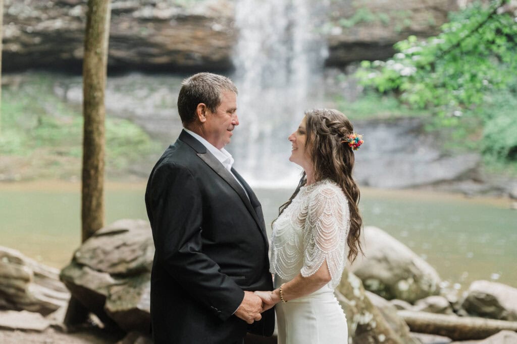 elopement couple standing at a waterfall during a cloudland canyon elopement