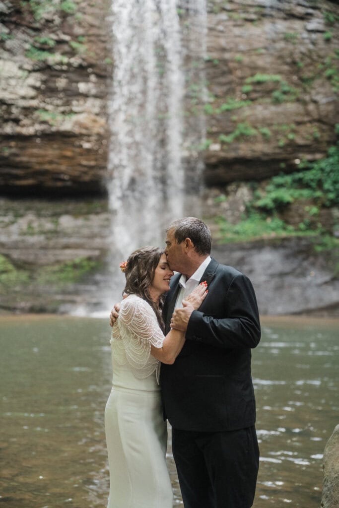 elopement couple standing at a waterfall during a cloudland canyon elopement