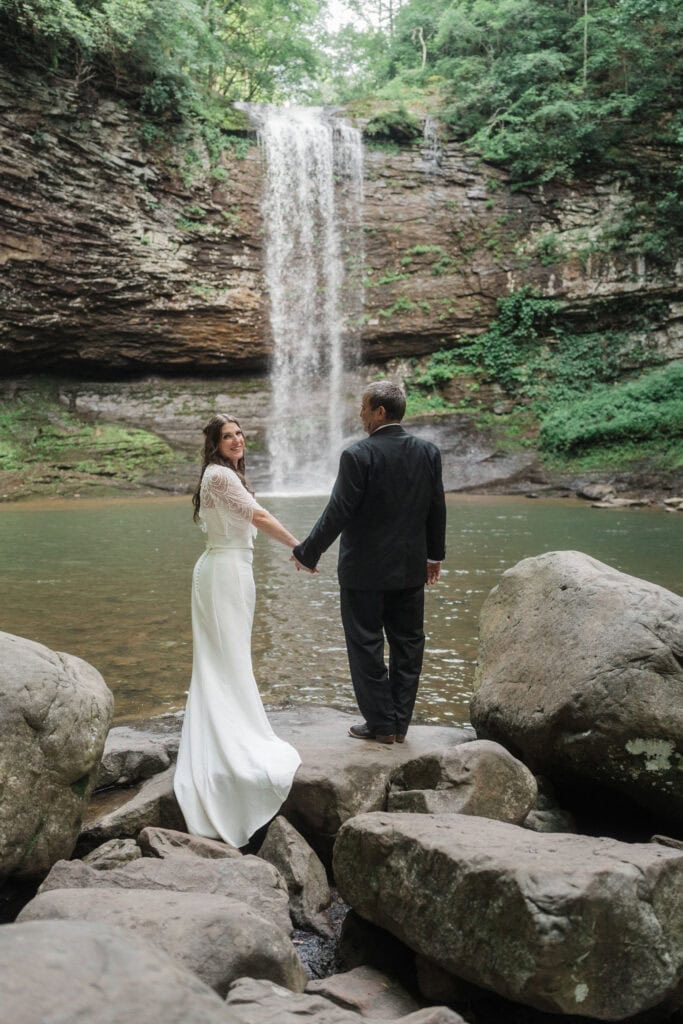 elopement couple standing at a waterfall during a cloudland canyon elopement