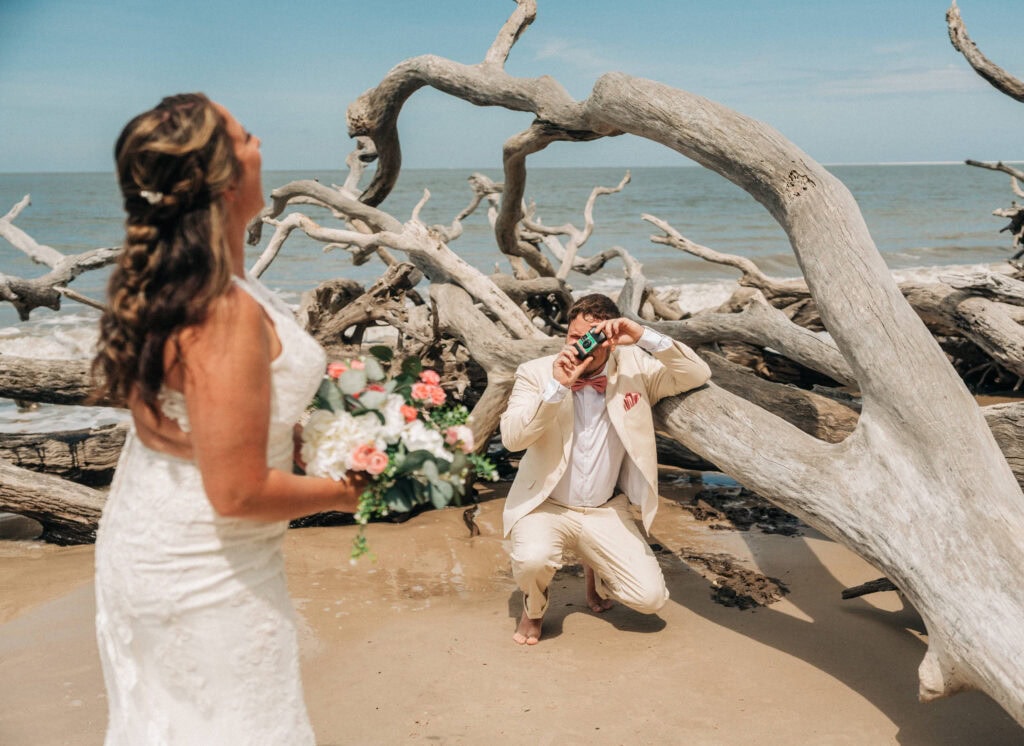 elopement couple surrounded by driftwoods on a florida beach