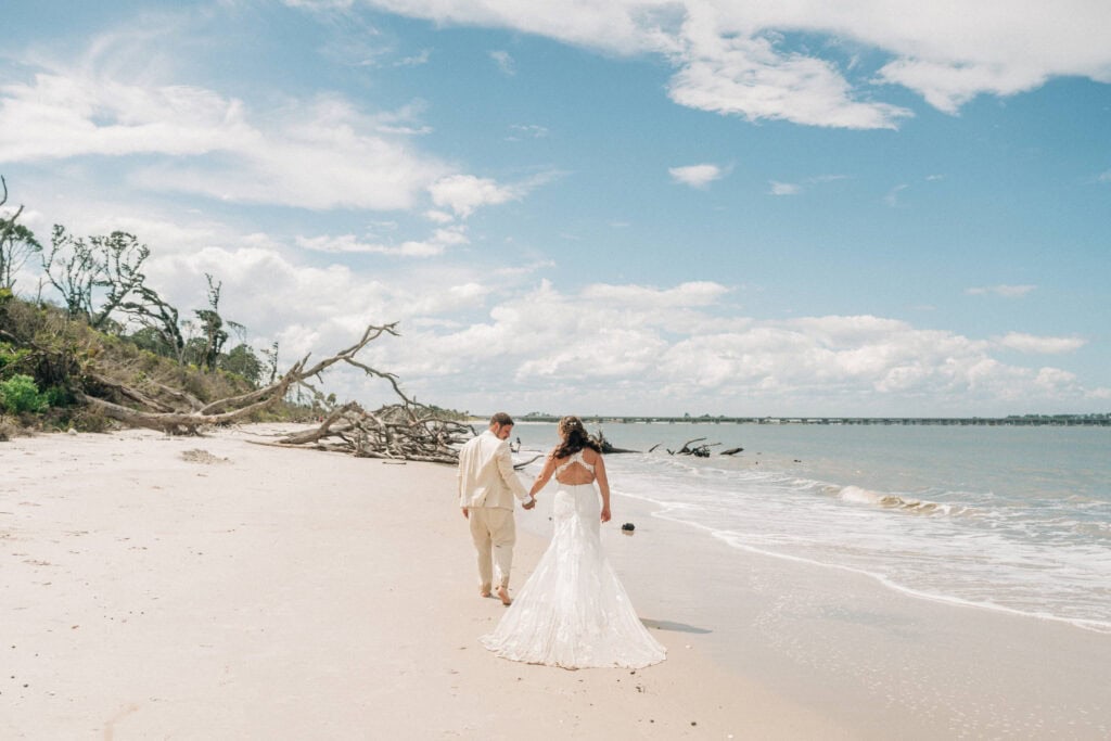 elopement couple surrounded by driftwoods on a florida beach