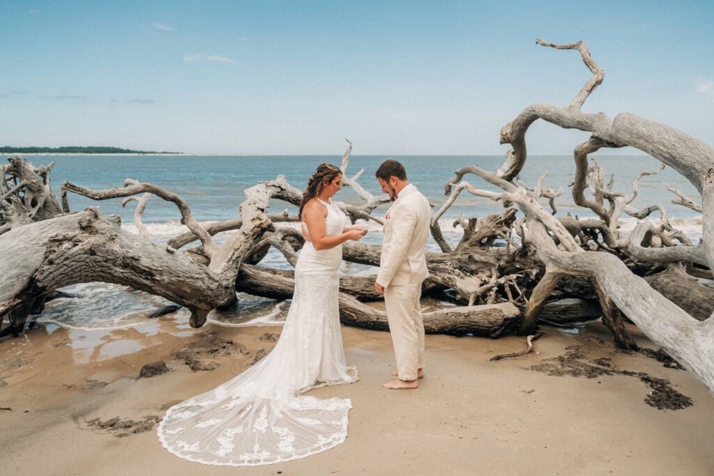 elopement couple exchanging vows surrounded by driftwoods on a florida beach