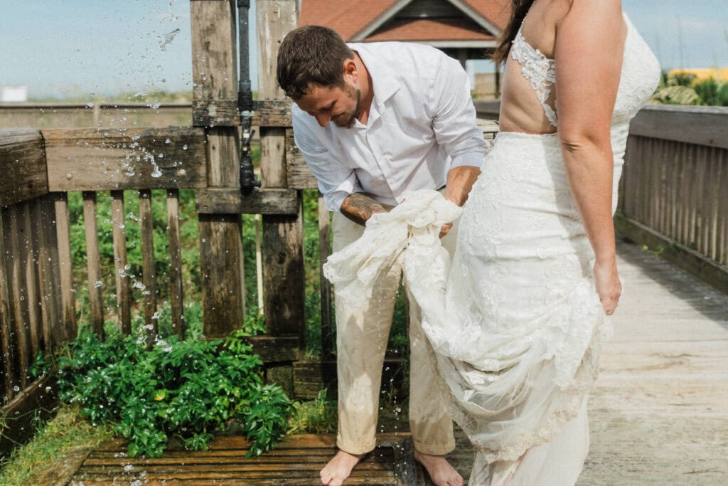 elopement couple rinsing off their feet at a shower in florida