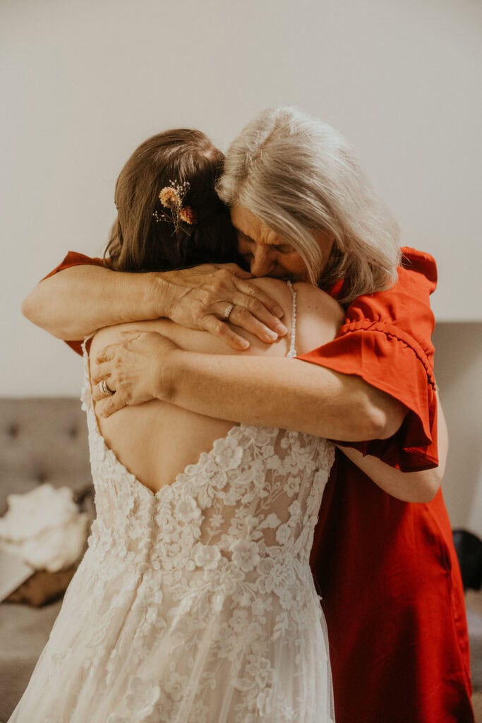 bride and mom hugging
