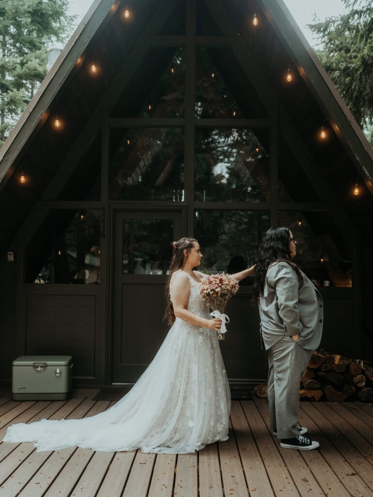 elopement couple first look outside their a frame cabin in mt rainier national park