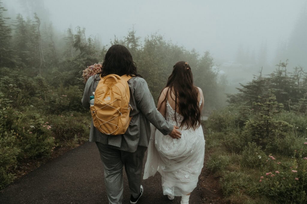 elopement couple wandering around the landscapes of mt rainier national park