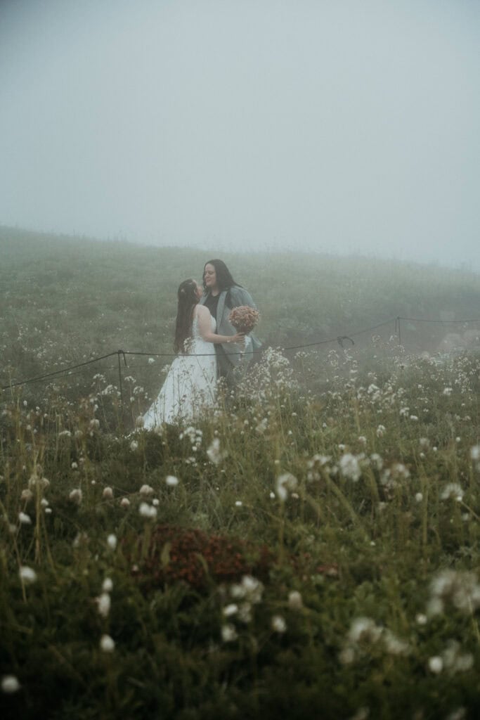 elopement couple hugging in a wildflower field during their mt rainier wildflower elopement