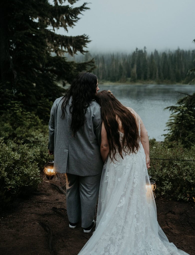 elopement couple holding lanterns during their moody elopement in mt rainier national park
