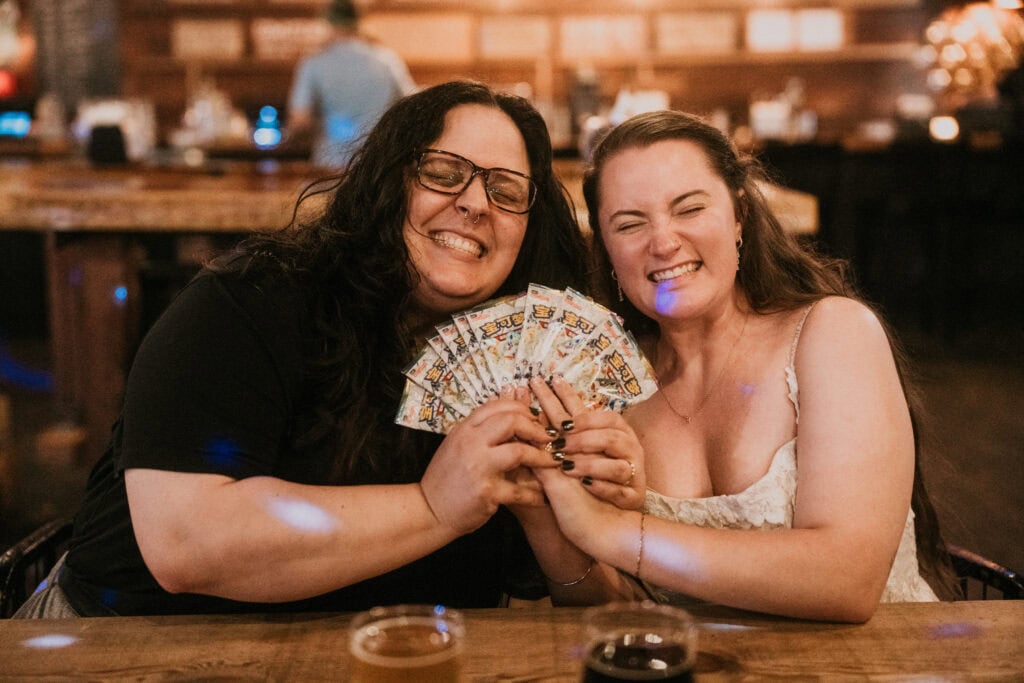 elopement couple unpacking pokemon cards together in a rustic brewery