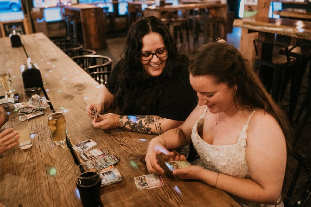 elopement couple unpacking pokemon cards together in a rustic brewery