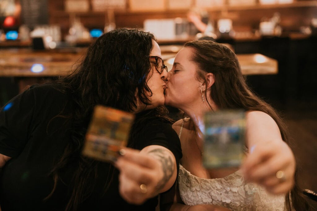 elopement couple unpacking pokemon cards together in a rustic brewery